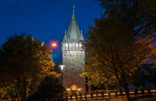 Church tower made of stone in Karpacz at night.