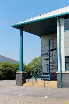 Entrance to modern office building with spiral staircase.