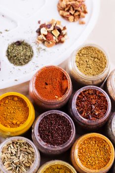 Assorted spices and dry tea in boxes and palette