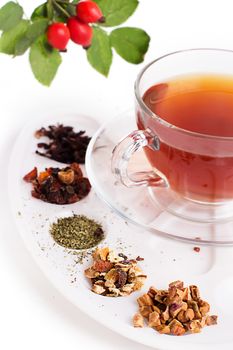 Assortment of dry tea in palette, isolated on white