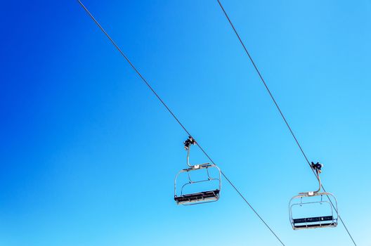 Looking up at a chairlift with a beautiful deep blue sky