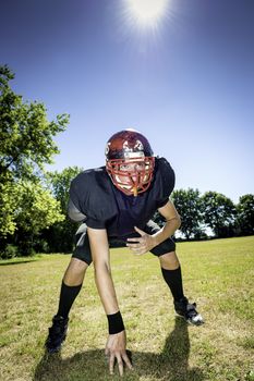American football player offensive Lineman in three point stance