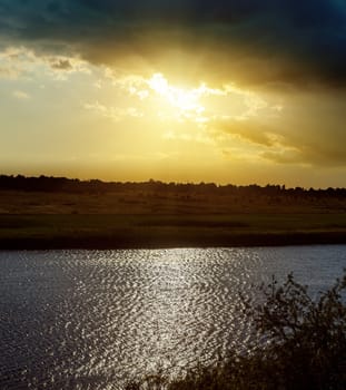 dramatic sunset and river with reflections