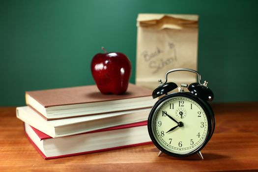 Clock Apple and Stack of Books on A Desk for Back to School