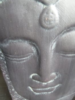 Sleeping Buddha's face on a ceramic pot