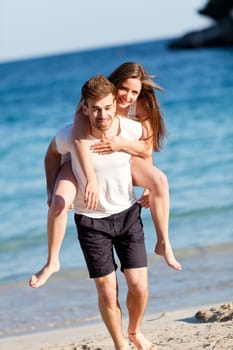 happy young couple on the beach in summer holiday love togetherness