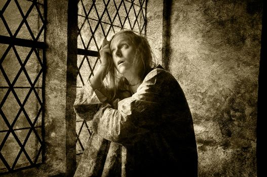 Mentally ill woman looking out of a window in a medieval building, 