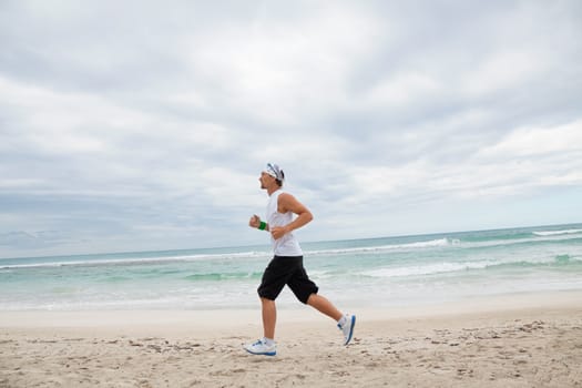 man is jogging on the beach summertime sport fitness run jogger runner