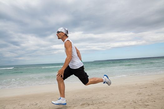 man is jogging on the beach summertime sport fitness run jogger runner