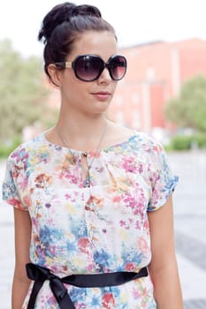 attractive woman with sunglasses in the city summertime portrait lifestyle smiling