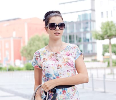 attractive woman with sunglasses in the city summertime portrait lifestyle smiling