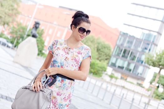 attractive woman with sunglasses in the city summertime portrait lifestyle smiling