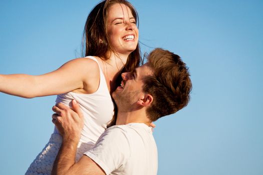 attractive young couple in love summertime on beach smiling romance