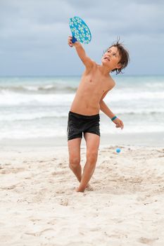 happy little child kid boy  playing beachball on beach in summer vacation holiday