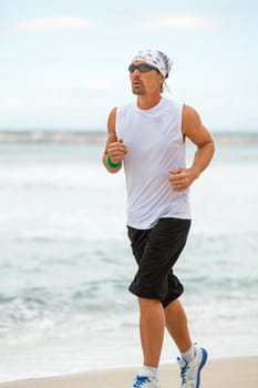 man is jogging on the beach summertime sport fitness run jogger runner