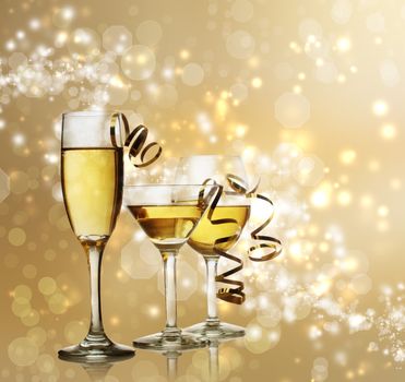 Assorted Wine, Champagne and Cocktail  Glasses on a Sparkling Gold  Backdrop