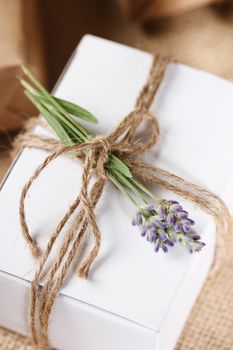 White Present box with rustic twine and sprig of lavender 