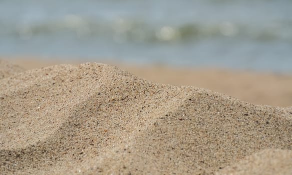 fragment of a sandy beach with the sea in the background