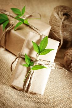 Natural style handcrafted gift boxes with rustic twine on burlap