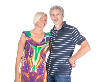 Smiling attractive middle-aged couple standing close together looking at the camera isolated on white