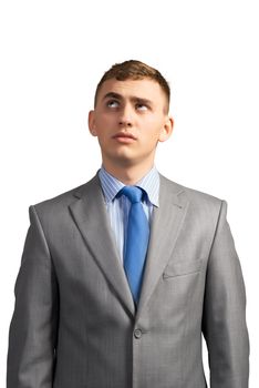 portrait of a young businessman thinking and looking up on gray background, isolated on white background