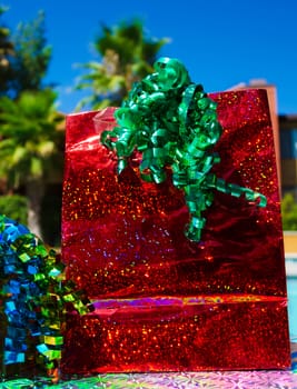 Red Gift bag with ribbon by the swimming pool 