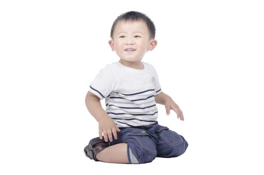 Smiling kid sit on the floor over white background