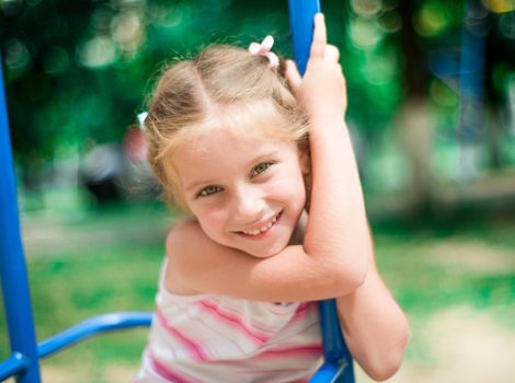 beautiful smiling little girl on a playground