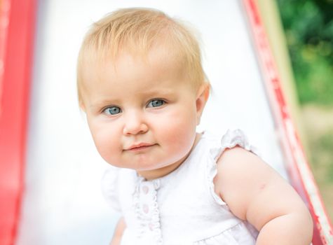 beautiful smiling little girl on a playground