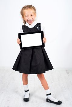 cute schoolgirl with a pc tablet on light background