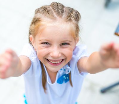 cute little girl smiling in a park close-up