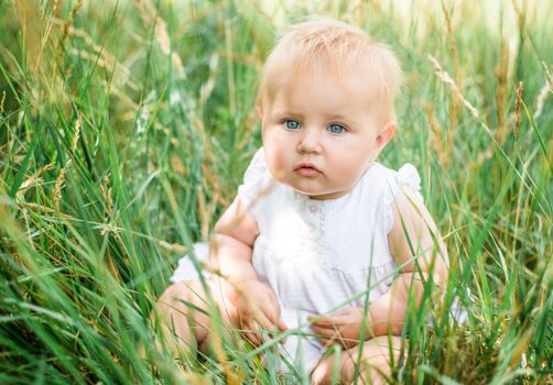 cute beautiful baby in green grass