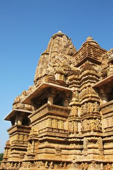 A temple in the Kajuraho temple complex in Madhya Pradesh state in India - the largest group of medieval hindu erotic teples. The coplex is a popular tourist destination.