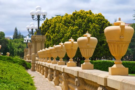 Row of tall urns sitting on railing at Stanford University