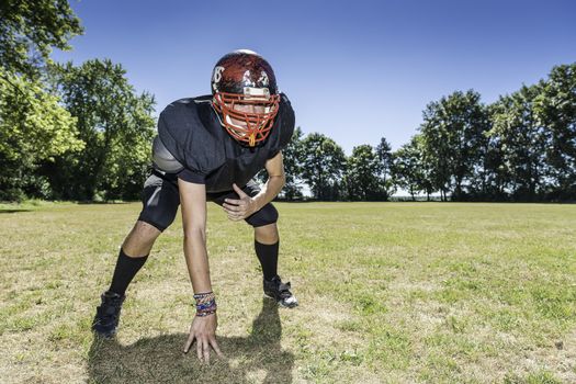 American football player offensive Lineman in in action at three point stance