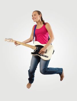 young woman playing on electro guitar and jumping