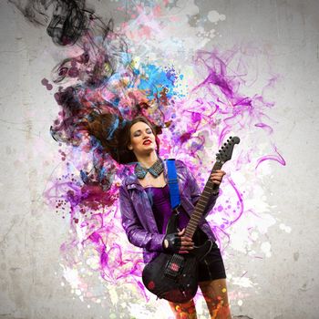 Young attractive rock girl playing the electric guitar