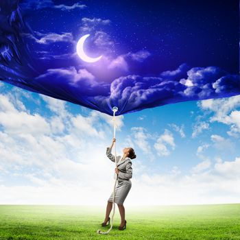 Image of businesswoman pulling banner with illustration. Day and night concept