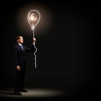 Image of handsome businessman against dark background