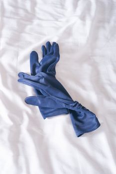 blue gloves on a white sheet