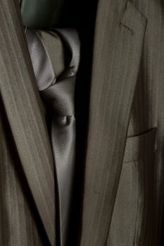 A close-up shot of an elegant formal mens suit with a tie