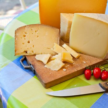 Pecorino sardo cheese slices on wooden board