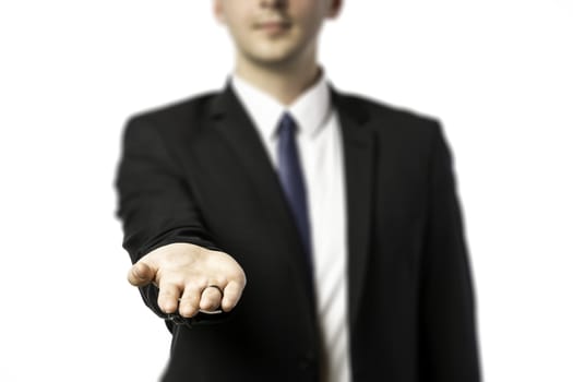 Businessman in dark suit holds out his hand flat isolated on white background