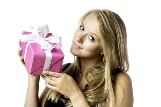 Pretty blond young girl with blue eyes has a birthday or christmas present