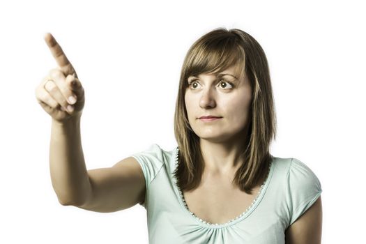 Young girl shows a finger at something, isolated on white background