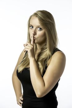 Young girl with finger on her mouth, isolated on white background