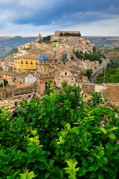 Beautiful village Ragusa with green tree in foreground, Sicily, Italy