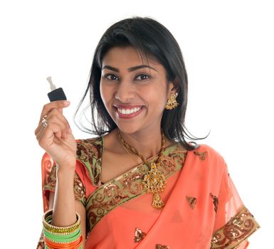 Estate agent. Happy Traditional Indian business woman or realtor showing keys. Isolated over white background.
