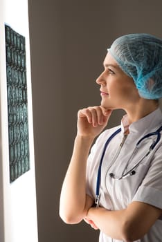 female doctor looking at the x-ray image attached to the glowing screen