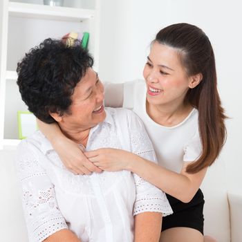 Senior woman and daughter. Happy Asian family senior mother and adult offspring having fun time at home.